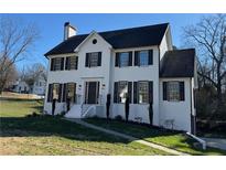 Two-story white brick home with black shutters and a landscaped lawn at 2907 Wickford Nw Dr, Kennesaw, GA 30152
