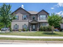 Two story house with gray siding, landscaping and a large front yard at 15 Blanket Pass, Covington, GA 30016