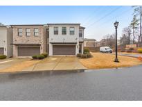 Modern townhome with two-car garage and landscaped front yard at 1017 Rohner Way, Smyrna, GA 30080