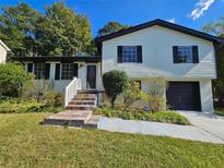 Charming ranch home with a stone walkway and attached garage at 6692 Cambridge Dr, Rex, GA 30273