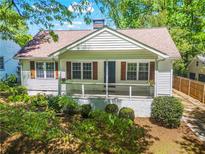 Charming ranch home with a covered porch and landscaped yard at 311 Deering Nw Rd, Atlanta, GA 30309