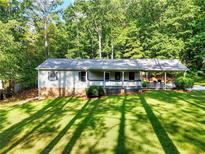 Ranch style home with covered porch and large yard at 3365 Claude Brewer Rd, Loganville, GA 30052