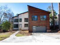 Striking contemporary home boasts a unique design with mixed materials and clean lines at 4238 Paces Ferry Se Rd, Atlanta, GA 30339