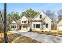 Beautiful new construction showcases traditional architecture with large windows and attractive neutral colors at 101 Forsyth Park Ln, Woodstock, GA 30188