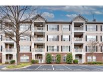 Three-story condominium building with brick and siding exterior and balconies at 4333 Dunwoody Park # 2113, Dunwoody, GA 30338