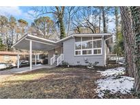 Gray brick ranch house with carport and landscaped yard at 2280 Connally Ct, Atlanta, GA 30344
