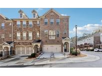 Brick front of a charming townhome with a two-car garage at 4051 Townsend Ln, Atlanta, GA 30346