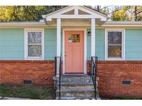 Charming home with a colorful front door and brick foundation at 116 Turman Se Ave, Atlanta, GA 30315