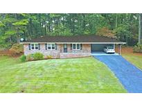 Brick ranch house with carport and large yard at 1792 Hammond Woods Sw Cir, Marietta, GA 30008