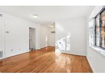 Bright living room features hardwood floors, white walls, and large window for ample natural light at 320 3Rd Ne St # 1, Atlanta, GA 30308