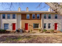 Three-unit townhome building with red doors and brick accents at 242 Chads Ford Way, Roswell, GA 30076