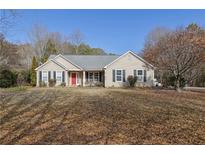 Ranch style home with a large front yard and mature trees at 1460 Chamblee Gap Rd, Cumming, GA 30040