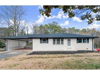 Newly renovated ranch home with carport and landscaped yard at 1955 E Lake Dr, Marietta, GA 30066