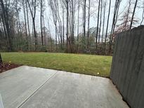 Private backyard with grassy lawn and concrete patio at 3305 Cranston Ln, Kennesaw, GA 30144