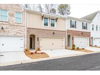 Brick townhome exterior with attached garage and landscaping at 3305 Cranston Ln, Kennesaw, GA 30144