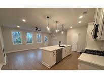 Open concept kitchen with island, stainless steel appliances, and white cabinets at 3305 Cranston Ln, Kennesaw, GA 30144