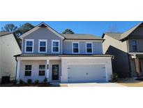 Two-story house with gray siding, white brick, and a two-car garage at 4453 Eastbrook Pl, Snellville, GA 30039