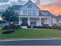 Two-story farmhouse with white siding, gray trim, and a landscaped front yard at 3177 Capriole Dr, Marietta, GA 30062