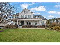 Charming two-story home with a welcoming front porch, landscaped yard, and classic architectural details at 3177 Capriole Dr, Marietta, GA 30062