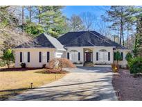 White one-story house with gray roof, black shutters, and a paved driveway at 1260 Lakehaven Pkwy, Mcdonough, GA 30253