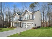 Charming two-story home with gray siding, a covered entry, and a two-car garage at 1612 Tide Mill Rd, Cumming, GA 30040