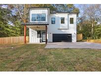 Modern two-story home with a black metal roof and paved driveway at 156 Martha Ne Ave, Atlanta, GA 30317