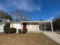 Brick house with covered porch and carport at 2043 Chicago Nw Ave, Atlanta, GA 30314