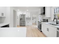 Bright kitchen with stainless steel appliances, white cabinets and hardwood floors at 501 Mcdaniel Nw Rd, Marietta, GA 30064