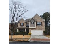 Brick two-story house with a large front yard and driveway at 2611 Cannon Farm Ln, Duluth, GA 30097