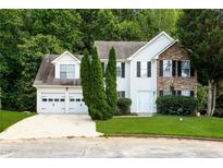 Charming two-story home with a two-car garage and a combination of stone and siding facade at 2295 Creekview Trl, Decatur, GA 30035