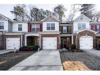 Brick front townhouse with two-car garage and landscaped yard at 3363 Fernview Dr, Lawrenceville, GA 30044