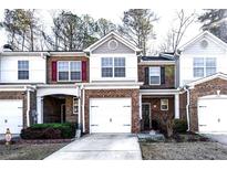 Brick townhouse with 2-car garage and landscaped front yard at 3363 Fernview Dr, Lawrenceville, GA 30044