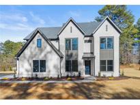 Two-story home with gray roof and white brick exterior at 3735 Tamiami Trl, Cumming, GA 30041