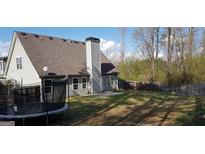 Spacious fenced backyard featuring a trampoline and ample room for outdoor activities and enjoyment at 520 Millbrook Village Dr, Tyrone, GA 30290