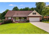 Ranch home with brick facade, attached garage, and a spacious lawn at 144 Bobs Sw Dr, Mableton, GA 30126