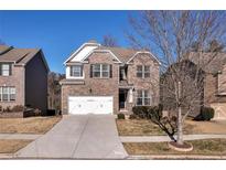 Brick two-story house with a two-car garage and landscaped yard at 2770 Blake Towers Ln, Buford, GA 30519