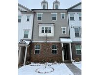 Stylish 3-story townhome with gray siding and brick accents at 397 Danville Ave, Suwanee, GA 30024