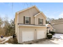 Two-story house with double garage and neutral siding at 4905 Bridle Point Pkwy, Snellville, GA 30039