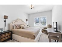 Spacious bedroom with a king-size bed and large window at 1 Ganel Ln, Alpharetta, GA 30009