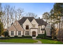 Stunning brick and stone two-story home with a large front yard at 4844 Elkhorn Hill Dr, Suwanee, GA 30024