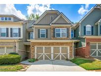 Charming townhome featuring a stone and siding facade with an attached two-car garage in a well-manicured community at 1503 Dolcetto Nw Trce # 2, Kennesaw, GA 30152