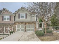 Two-story townhome with stone accents and a two-car garage at 1600 Watercress Se Ct, Mableton, GA 30126