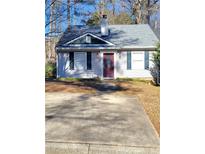 Cute ranch home with a gray roof, burgundy door and small front yard at 906 Westland Sw Dr, Marietta, GA 30064