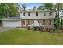 Two-story house with stone accents and a spacious lawn at 1529 Bell Flower Ct, Stone Mountain, GA 30088