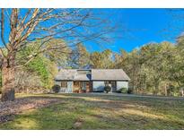 Ranch style home with wooded views and a spacious yard at 1963 Tripp Rd, Woodstock, GA 30188