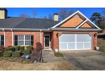 Brick ranch home with attached garage and landscaping at 2500 Rosehill Cir, Lithia Springs, GA 30122