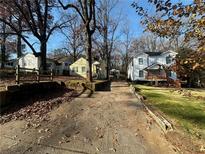 Cozy yellow house with a spacious yard and tree-lined street at 1591 Woodland Se Ave, Atlanta, GA 30316