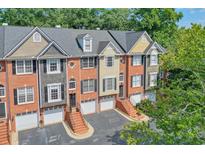 Brick townhouses with attached garages and landscaping at 1506 Lavista Proper Cir, Decatur, GA 30033