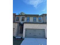 Brick front exterior of charming townhome with 2-car garage at 1346 Lucan Ln # Wc227, Lawrenceville, GA 30043