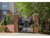 Brick building with gated entrance, landscaping, and a grand appearance at 50 Biscayne Dr # 2109, Atlanta, GA 30309